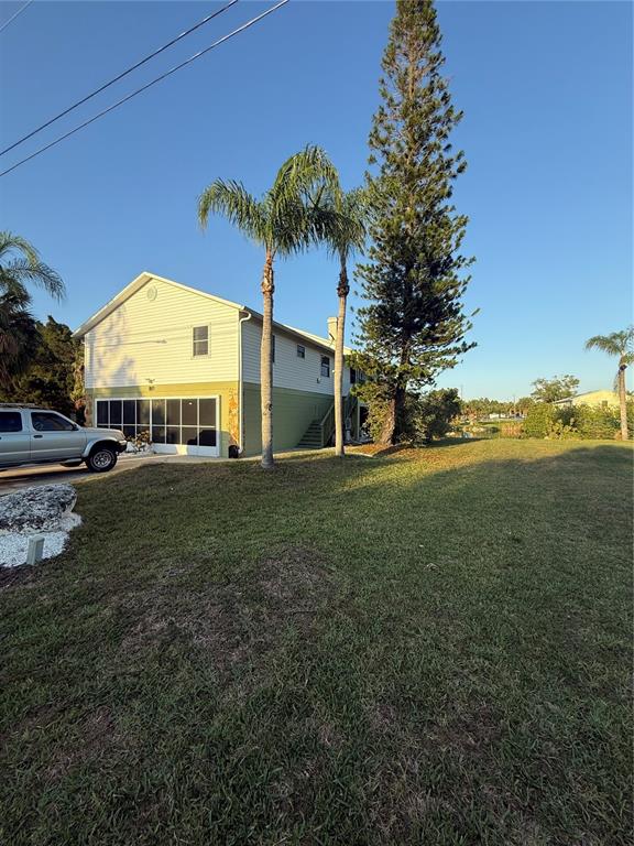 3338 Fernleaf Drive Hernando Beach, FL 34607 - Photo 5 of 69 a view of a house with a yard