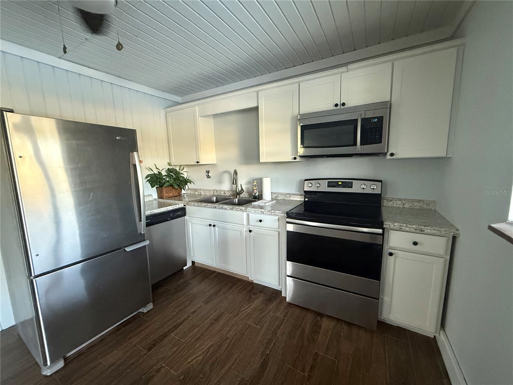 3338 Fernleaf Drive Hernando Beach, FL 34607 - Photo 54 of 69 a kitchen with a refrigerator sink and white cabinets