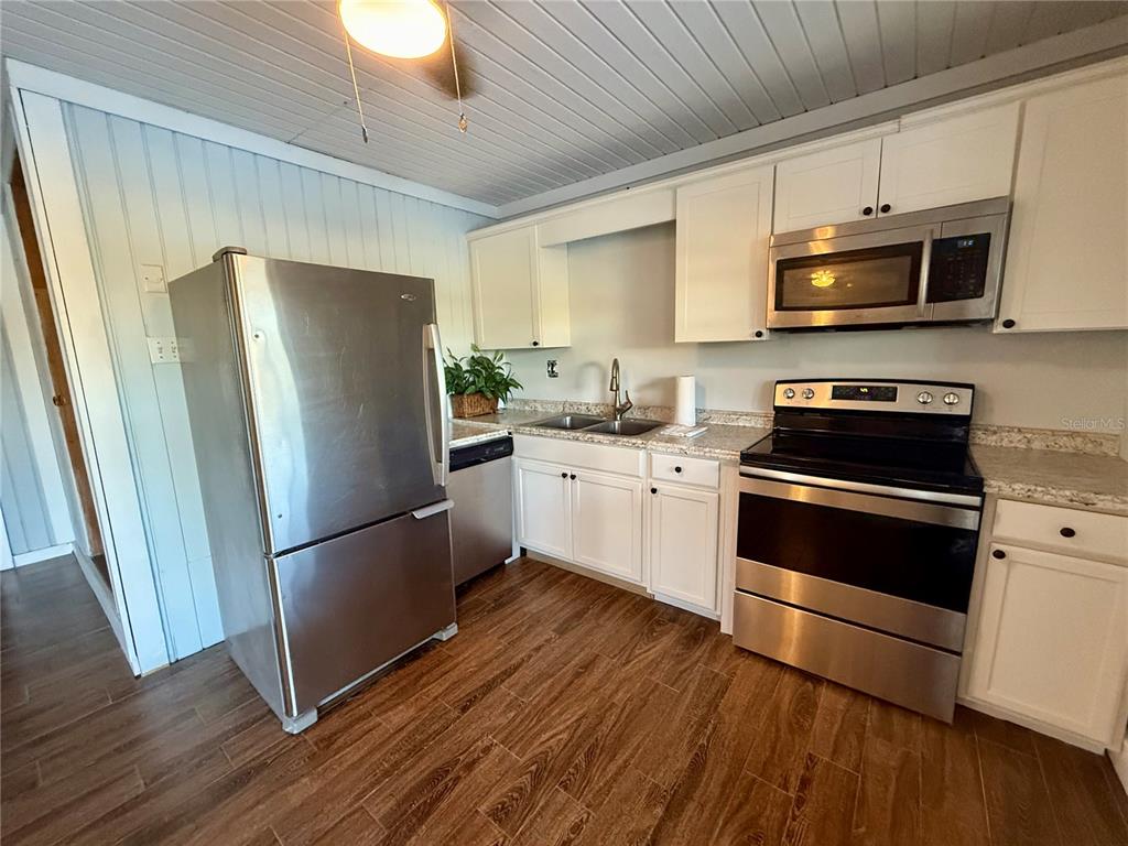 3338 Fernleaf Drive Hernando Beach, FL 34607 - Photo 55 of 69 a kitchen with stainless steel appliances a refrigerator sink and microwave