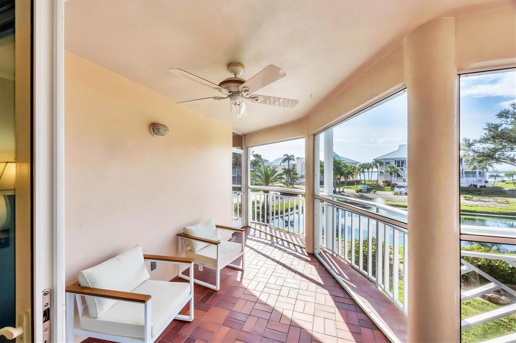 11000 Placida Road, Unit 2202 Placida, FL 33946 - Photo 13 of 58 a living room with furniture and a floor to ceiling window