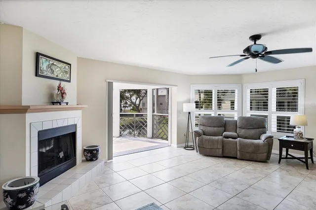 a spacious bedroom with a bed a couch and a chandelier