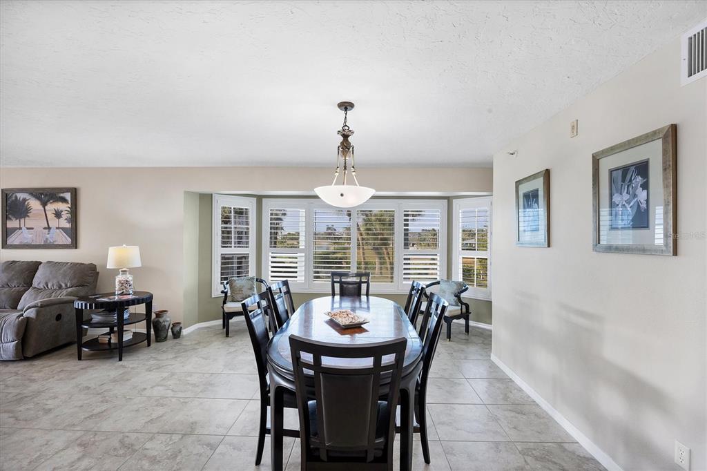 11000 Placida Road, Unit 2202 Placida, FL 33946 - Photo 20 of 58 a dining room with furniture a chandelier and a rug