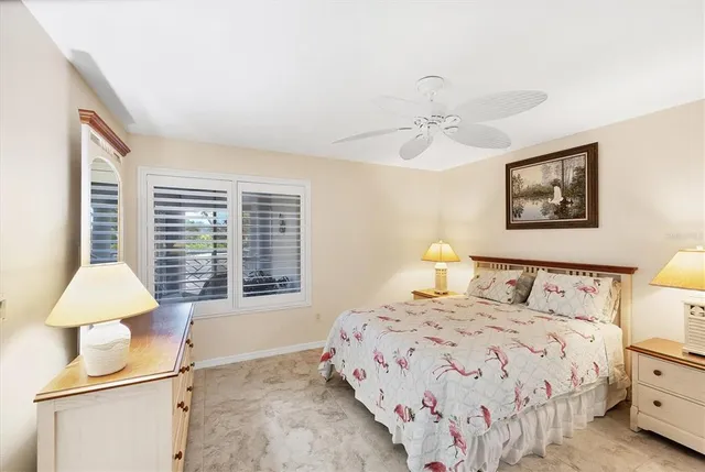 a view of a swimming pool with a chair and palm trees