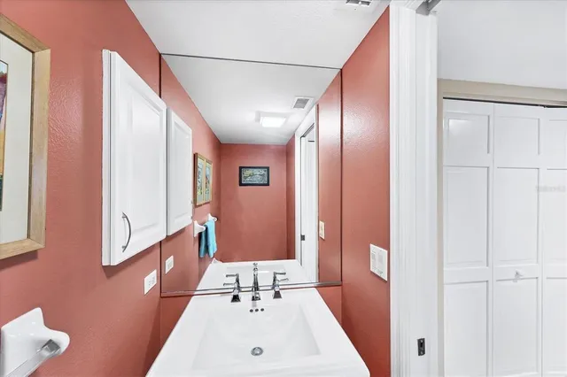 a view of a dining room and livingroom with furniture a rug a fireplace and a chandelier