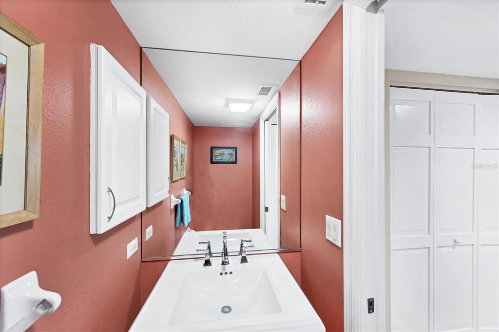 11000 Placida Road, Unit 2202 Placida, FL 33946 - Photo 27 of 58 a bathroom with a sink a toilet and a mirror
