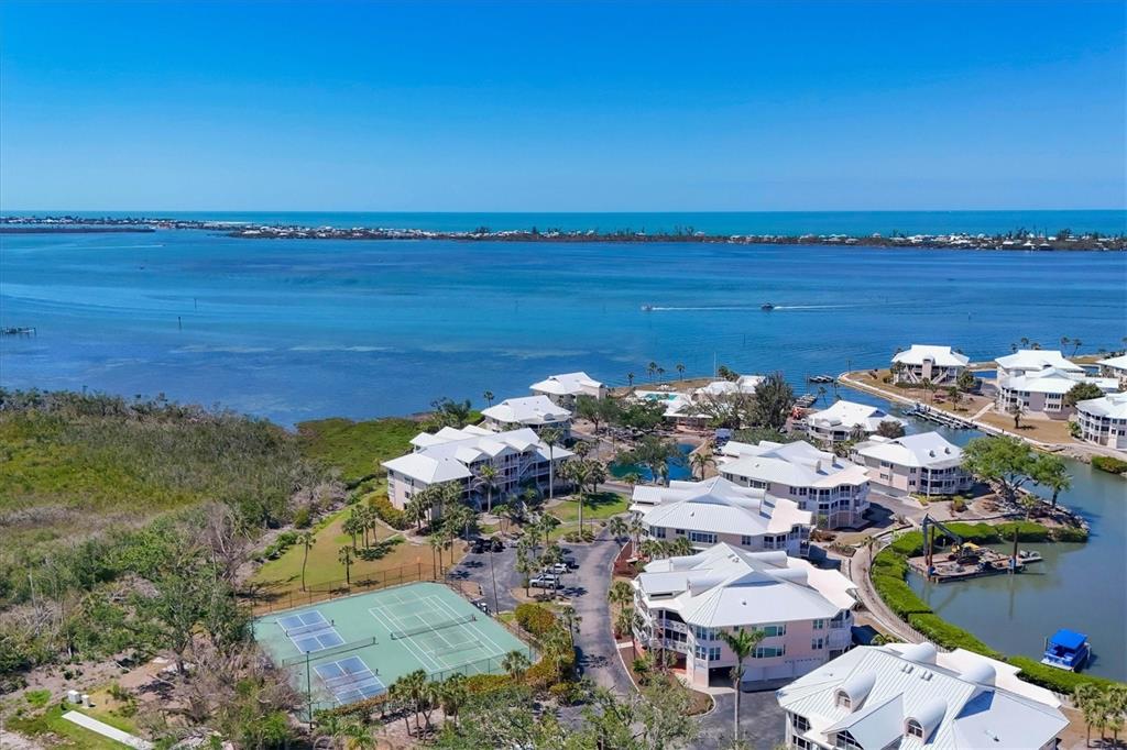 11000 Placida Road, Unit 2202 Placida, FL 33946 - Photo 51 of 58 a view of a lake with a building in the background