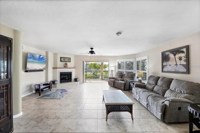 a living room with furniture and a floor to ceiling window