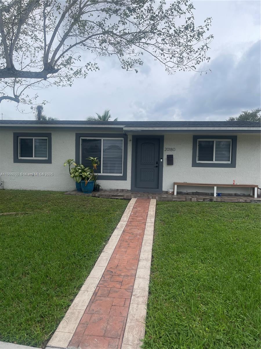20180 Northwest 14th Court Miami Gardens, FL 33169 - Photo 1 of 12 a front view of house with yard and green space