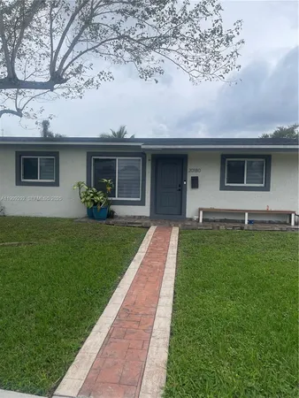a front view of house with yard and green space