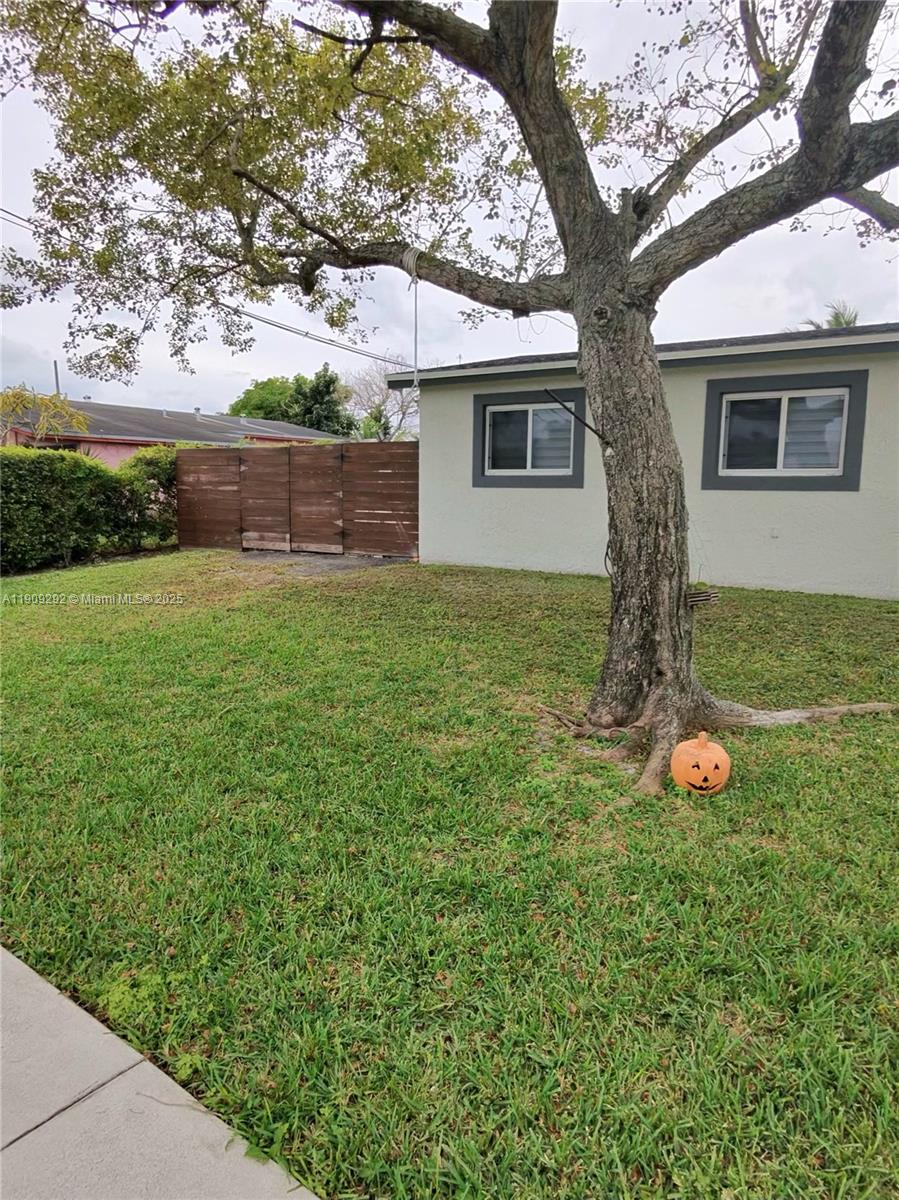 20180 Northwest 14th Court Miami Gardens, FL 33169 - Photo 3 of 12 a backyard of a house with lots of green space