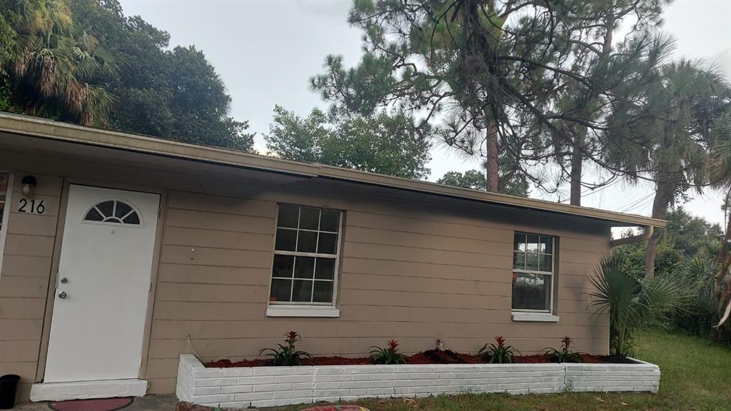 216 Maria Street Fort Myers, FL 33916 - Photo 1 of 19 a front view of a house with a yard