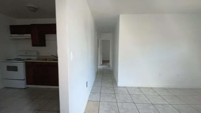 a view of a kitchen from the hallway