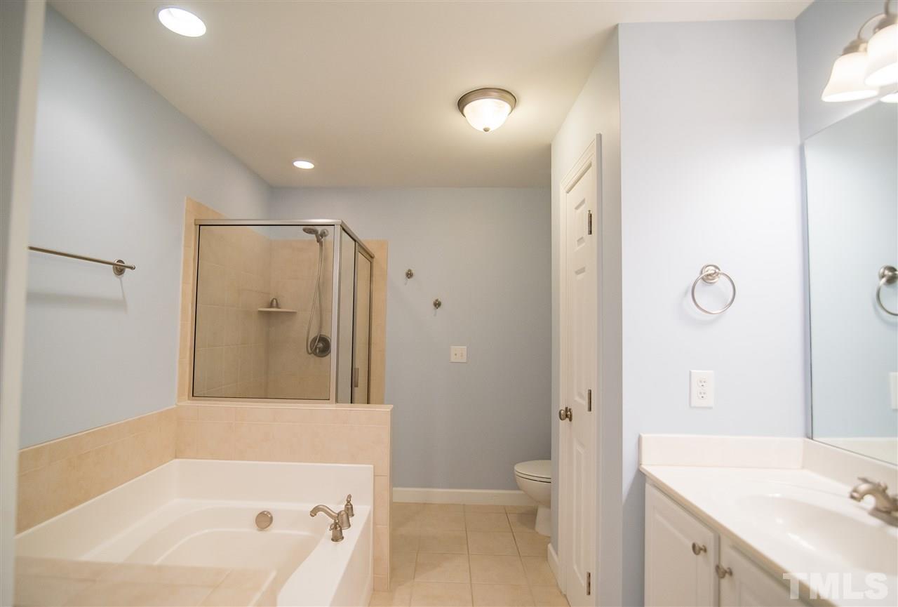 11006 Flower Bed Court Raleigh, NC 27614 - Photo 14 of 24 a bathroom with a tub sink vanity granite and shower