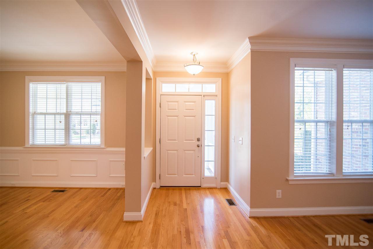 11006 Flower Bed Court Raleigh, NC 27614 - Photo 5 of 24 a view of an empty room with wooden floor and a window