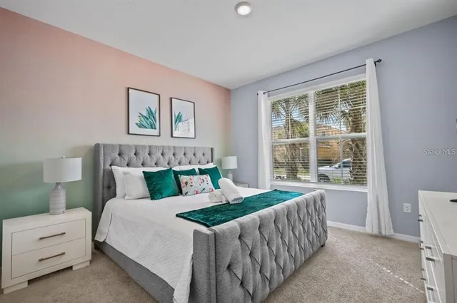 a bedroom with bed and window