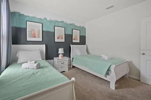 a bedroom with bed and window