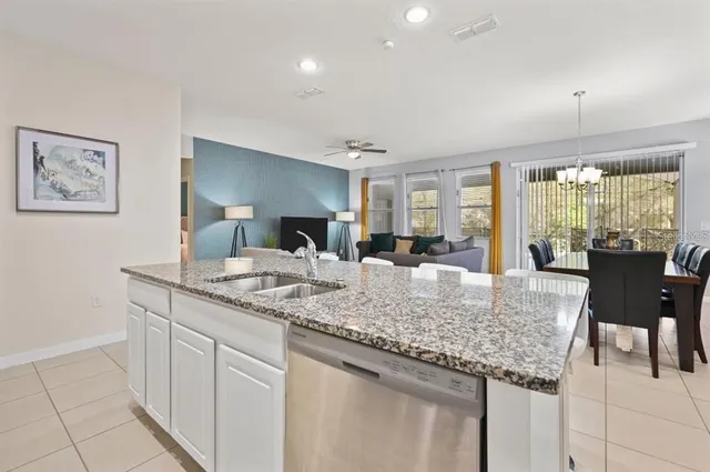 a kitchen with granite countertop kitchen island a sink and a stove
