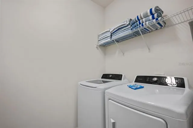 a view of a swimming pool with a patio and a yard