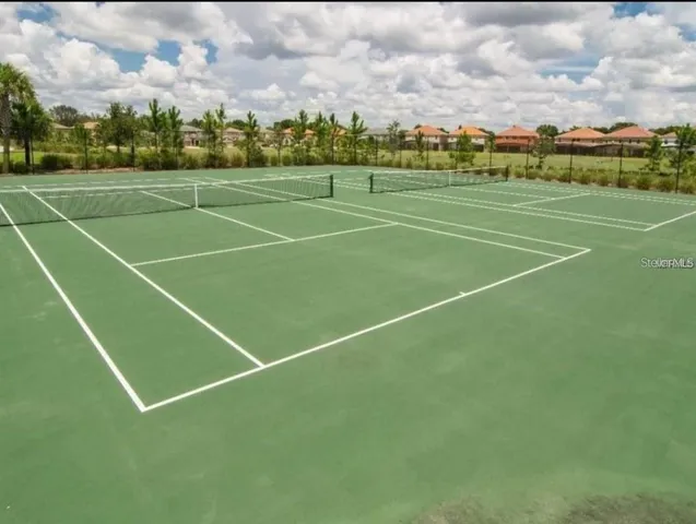 an outdoor space with patio and umbrellas