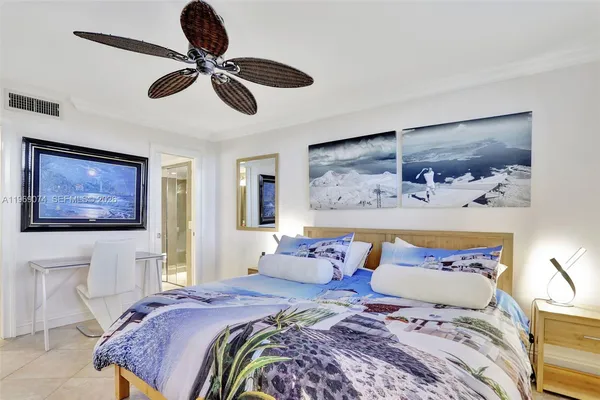 a bedroom with a bed and a painting on the wall