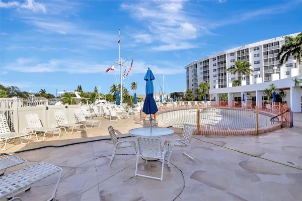 a swimming pool with outdoor seating and city view