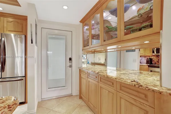 a view of a kitchen with stainless steel appliances granite countertop a refrigerator and a sink