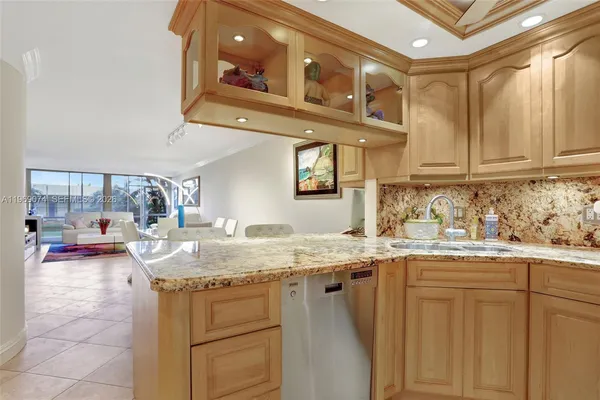 a kitchen with stainless steel appliances granite countertop a sink and cabinets