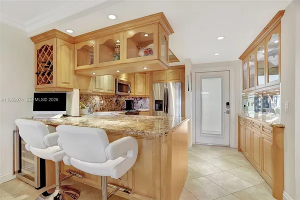 a hall with kitchen island granite countertop furniture and a fireplace
