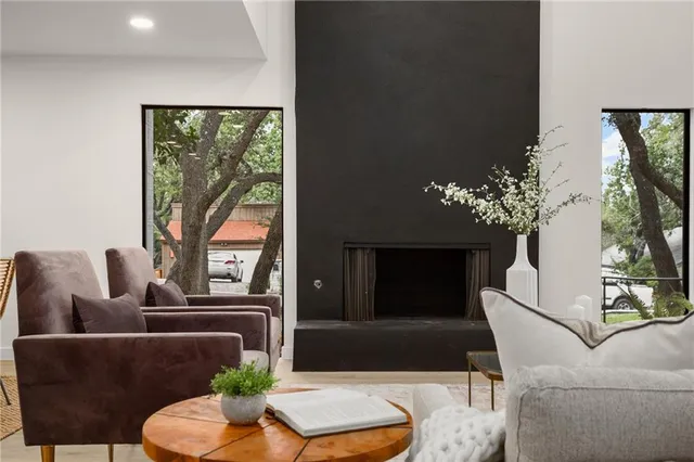 a living room with furniture and a potted plant