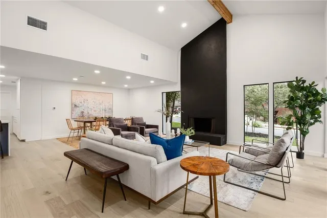 a dining room with furniture a large window and a rug