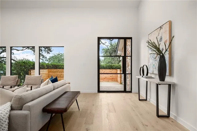 a living room with furniture and kitchen view