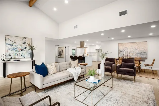 a bedroom with a large bed and a chandelier