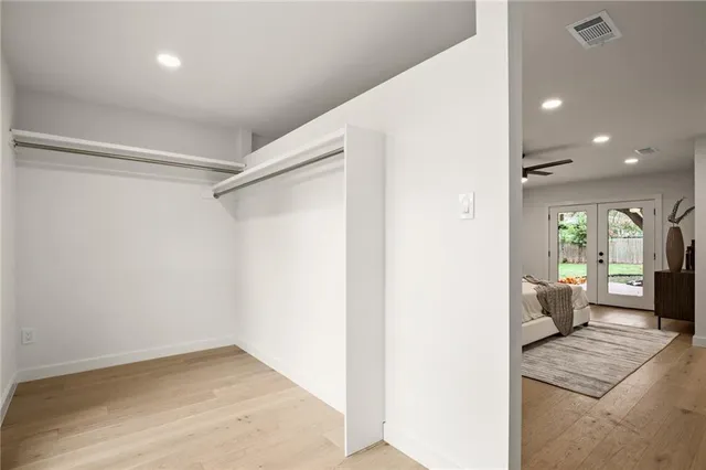 a bedroom with a bed and ceiling fan