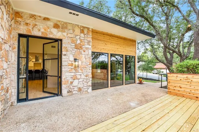 a front view of a house with a yard and trees