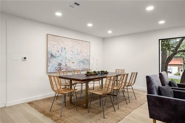 a view of a dining room with furniture and a large window