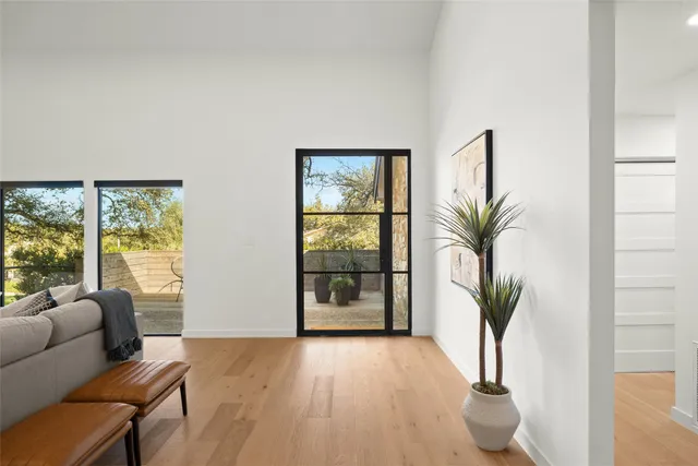 a living room with furniture and a potted plant