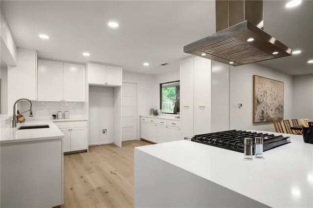 a kitchen with a sink stove and refrigerator