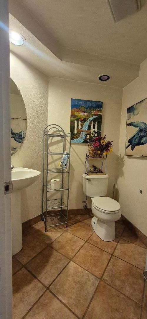 18047 Stonehaven Salinas, CA 93908 - Photo 6 of 19 a bathroom with a toilet a sink and mirror