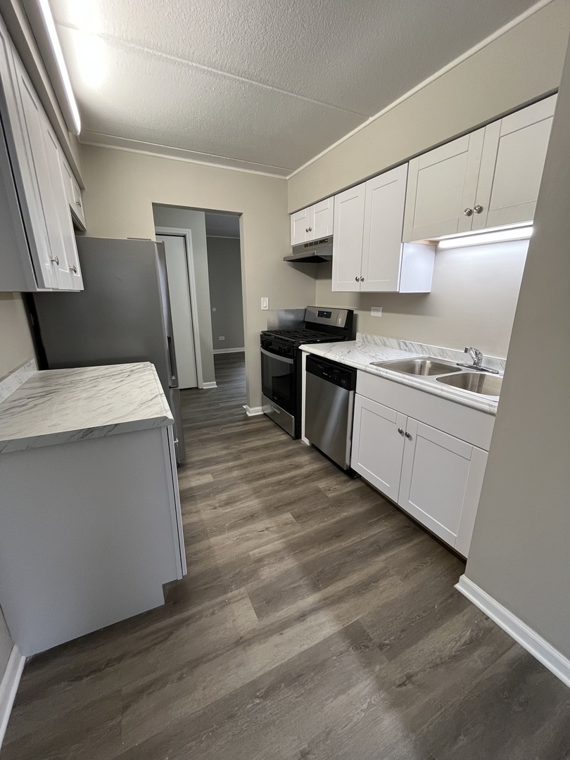 914 School Street, Unit 1 Lisle, IL 60532 - Photo 4 of 8 a kitchen with stainless steel appliances a refrigerator sink and stove