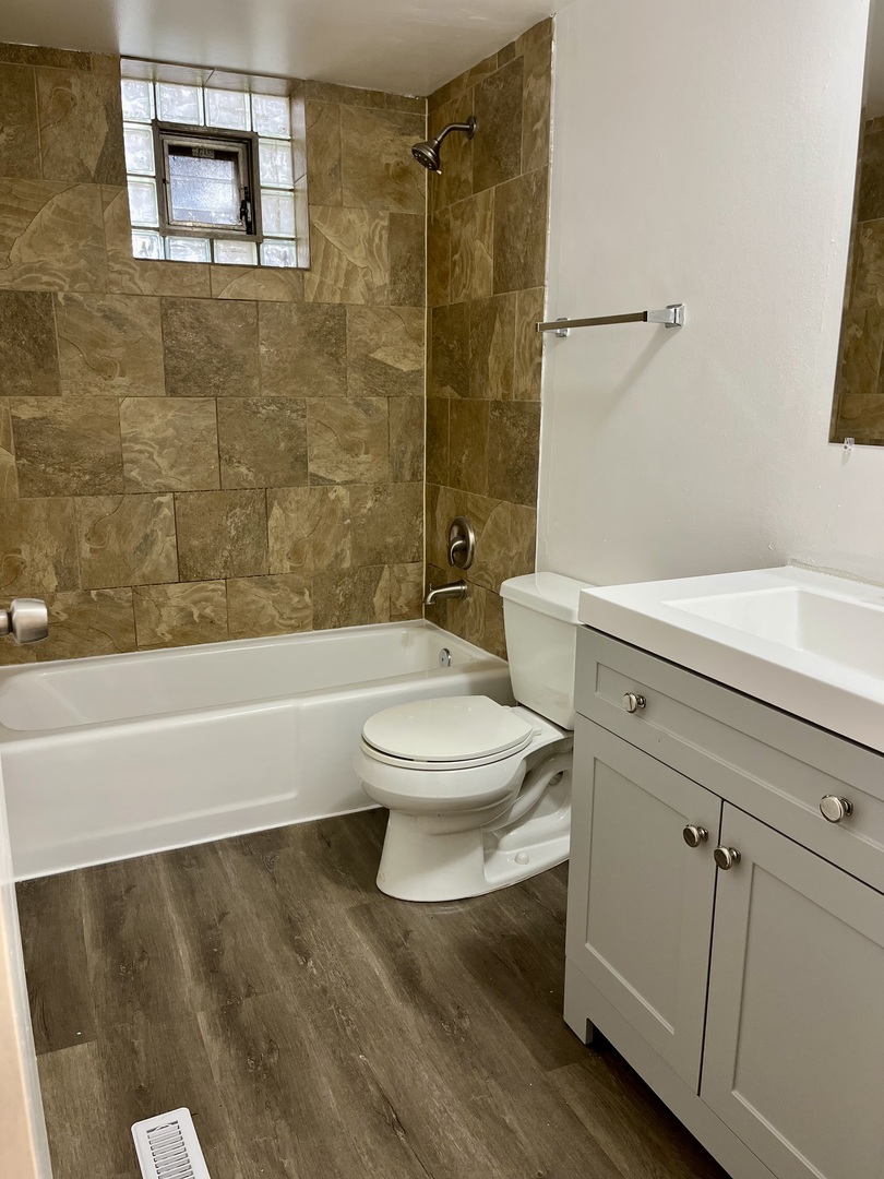 914 School Street, Unit 1 Lisle, IL 60532 - Photo 6 of 8 a bathroom with a toilet a sink and bathtub