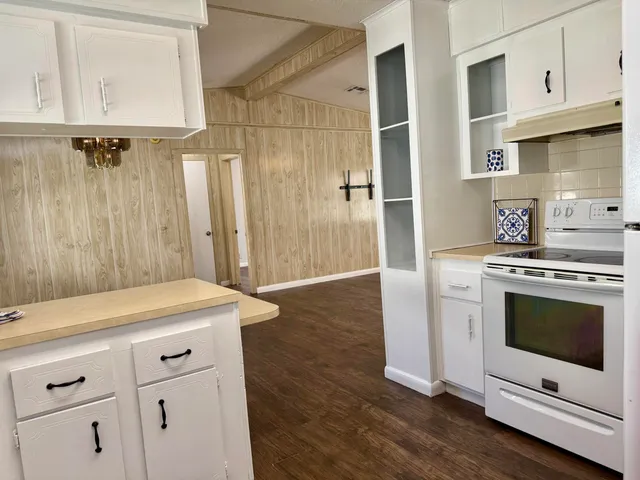 a kitchen with a stove oven and white cabinets