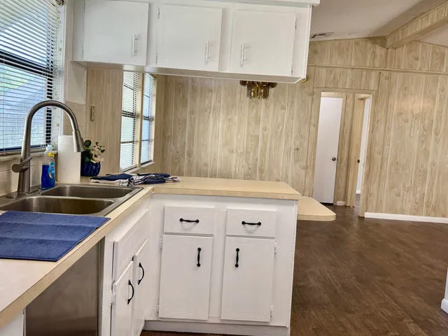 a spacious bathroom with a granite countertop sink and a large mirror