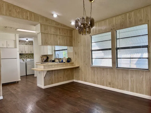 a kitchen with kitchen island a sink and a stove