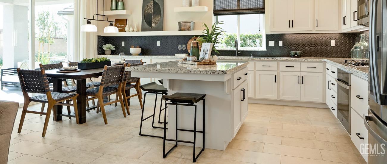 Undisclosed Address Bakersfield, CA 93314 - Photo 5 of 16 a kitchen with stainless steel appliances granite countertop a stove a sink and a refrigerator
