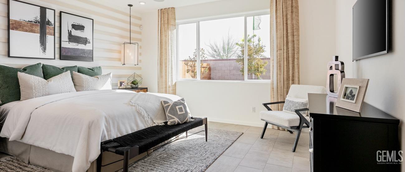 Undisclosed Address Bakersfield, CA 93314 - Photo 10 of 16 a bedroom with a bed chair and a window