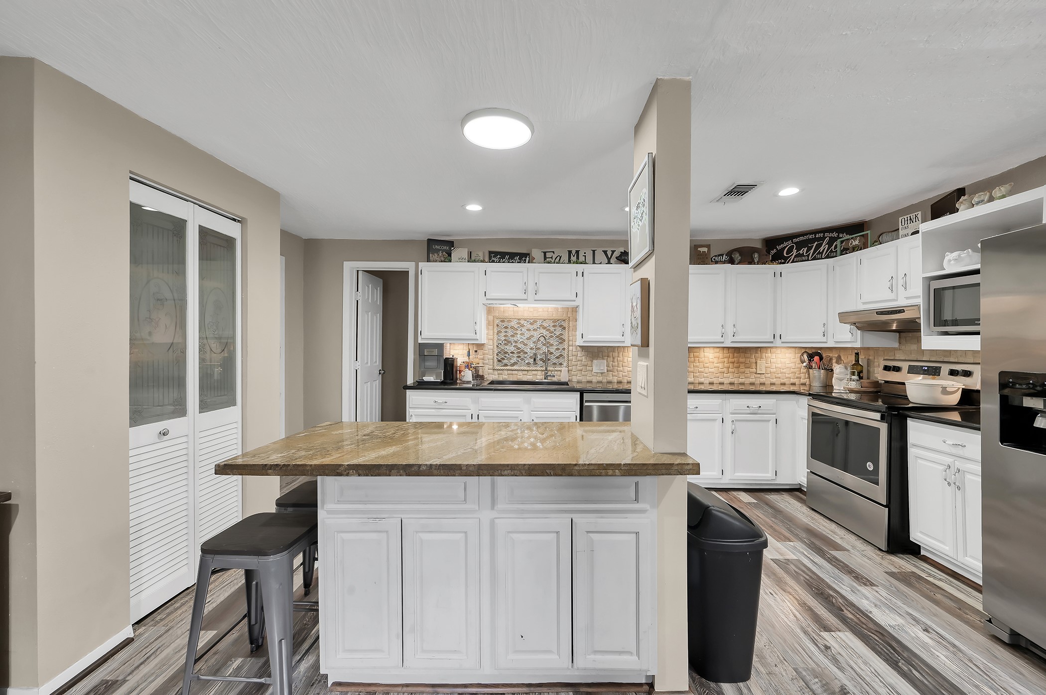 24193 Parker Road Porter, TX 77365 - Photo 4 of 15 a view of a kitchen with kitchen island a counter top space appliances and cabinets