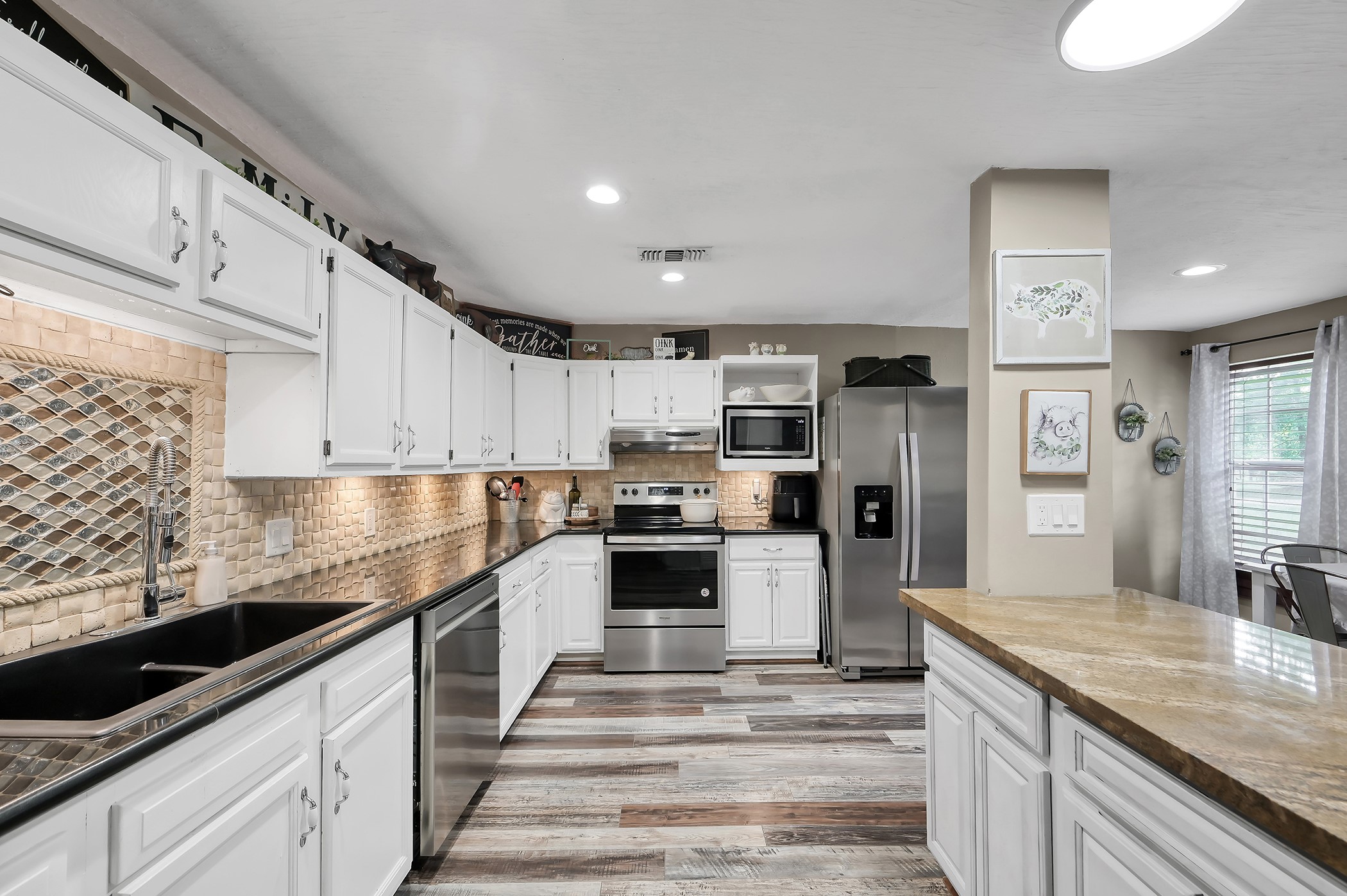 24193 Parker Road Porter, TX 77365 - Photo 5 of 15 a kitchen with kitchen island granite countertop a sink stainless steel appliances and cabinets