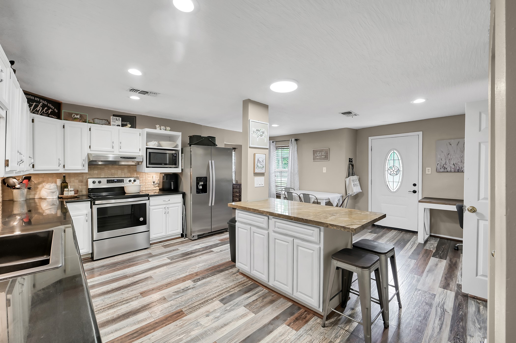 24193 Parker Road Porter, TX 77365 - Photo 6 of 15 a kitchen with stainless steel appliances kitchen island granite countertop a sink and cabinets