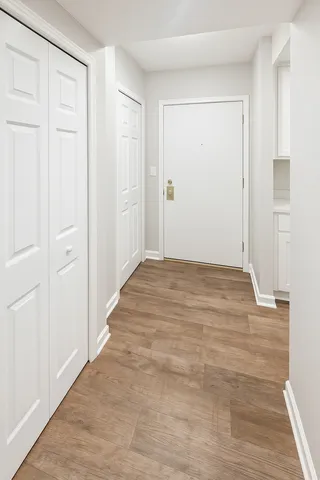 a view of an empty room with wooden floor