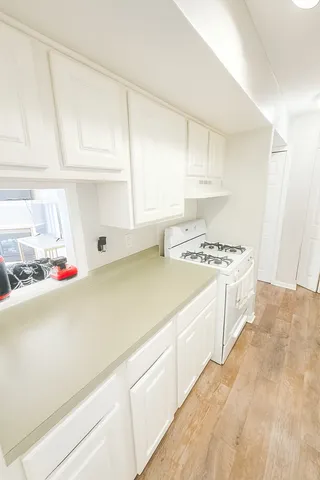 a utility room with cabinets washer and dryer